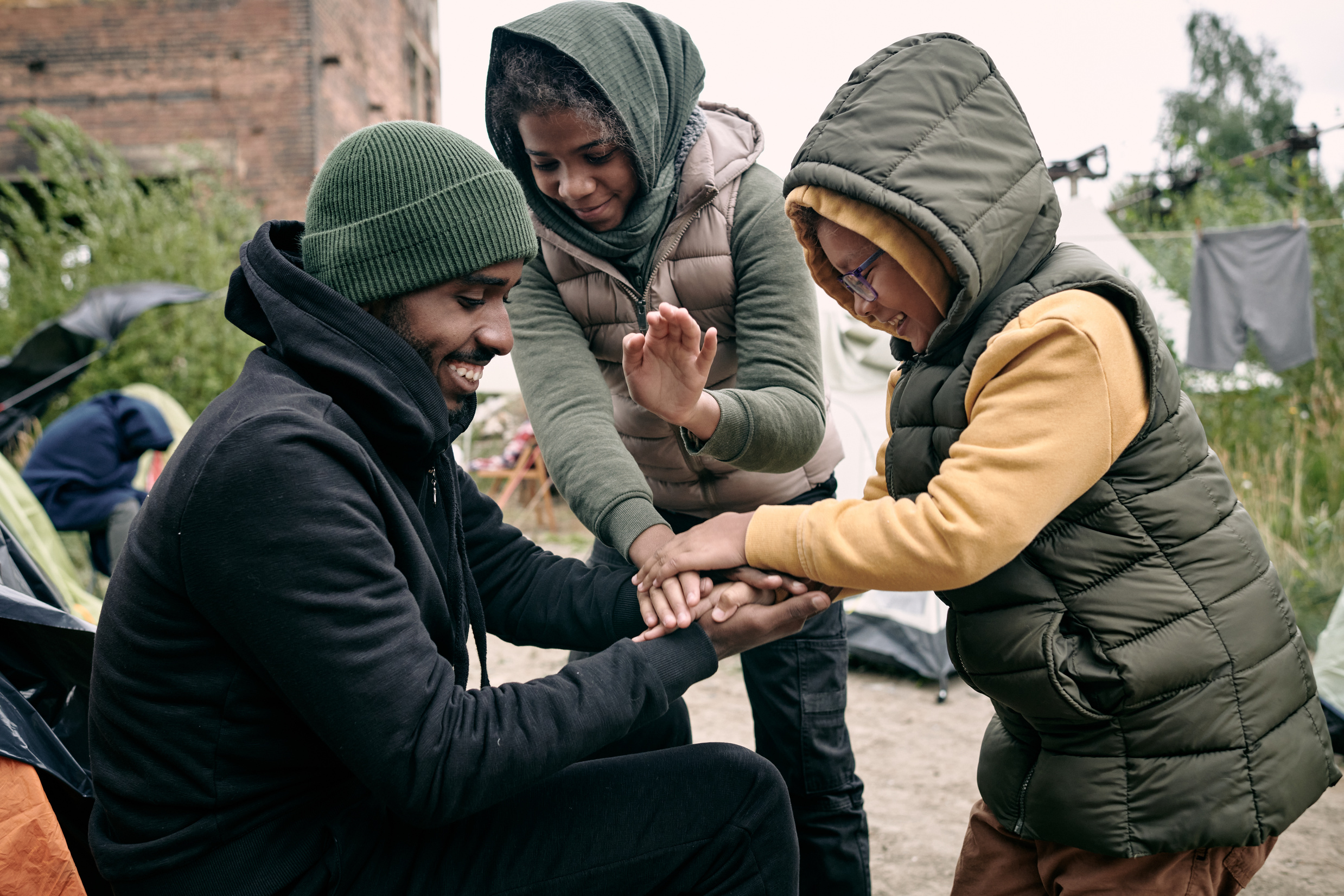 Man Playing With Kids In Refugee Camp