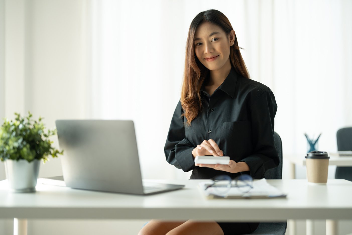 Portrait young Asian accountant enjoys working on computers